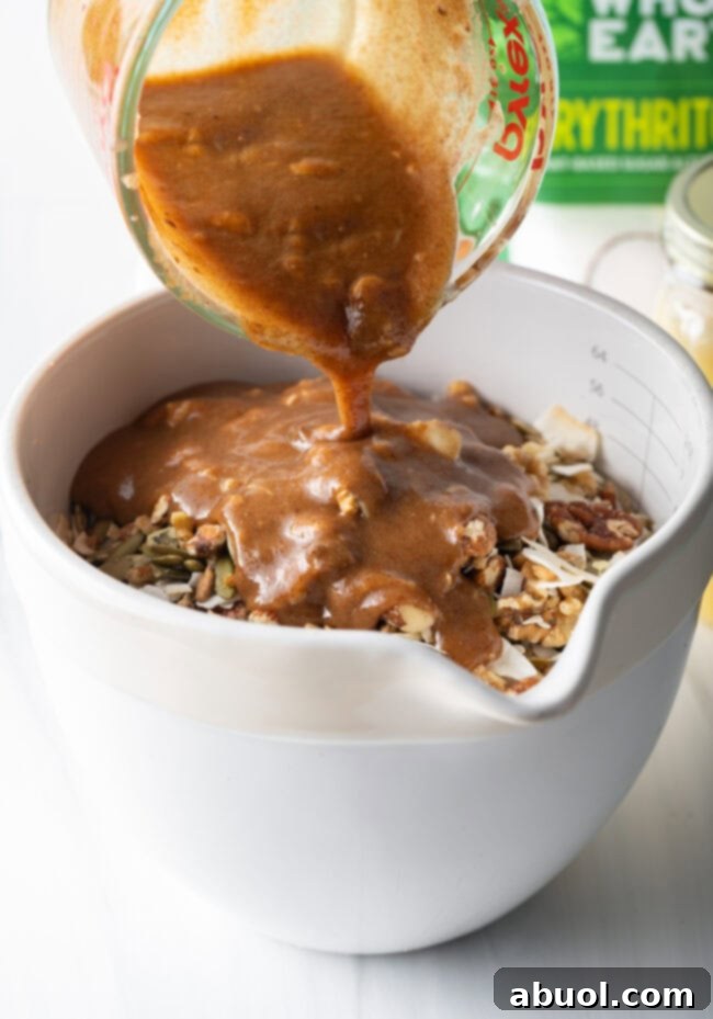 Ultimate Keto Granola Crunch 10 Granola mixture spread on a baking sheet before baking.