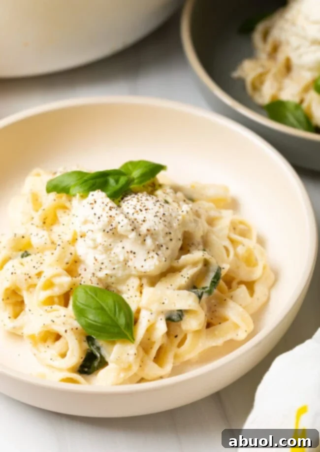 Bowl of creamy lemon ricotta pasta topped with fresh basil, ready to be enjoyed.