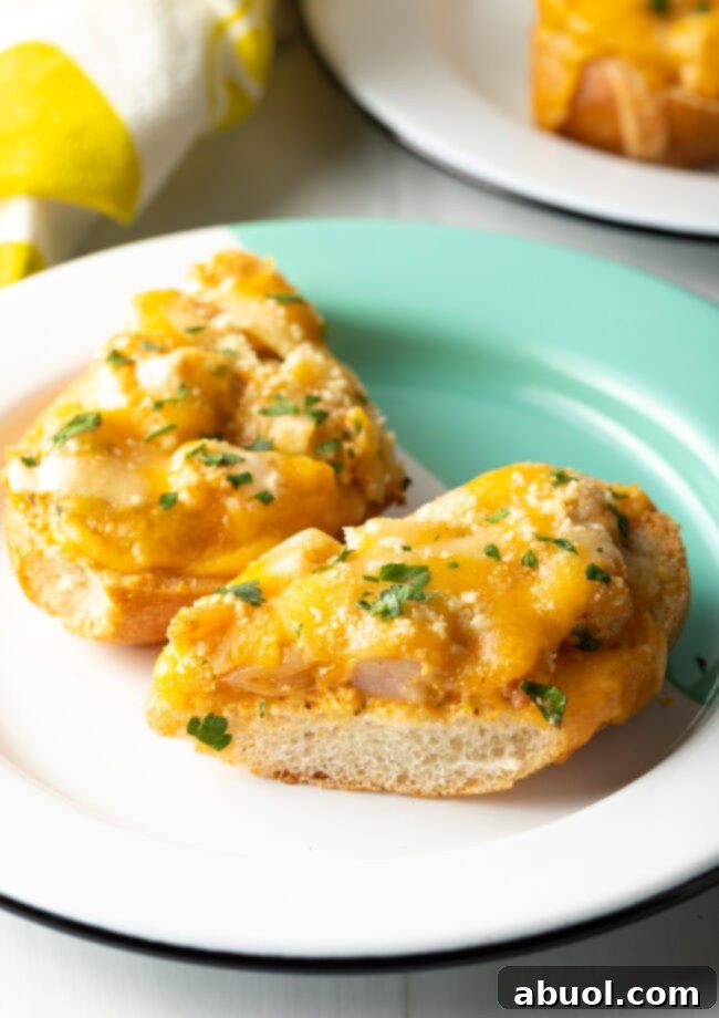 Two pieces of the delectable shrimp toast recipe arranged on a plate, garnished with fresh green herbs.