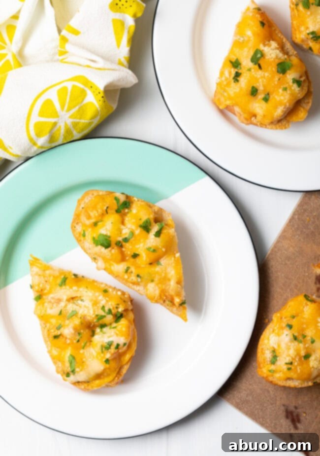 Top-down view of two pieces of Cajun shrimp bread served on a white plate, garnished with fresh parsley.