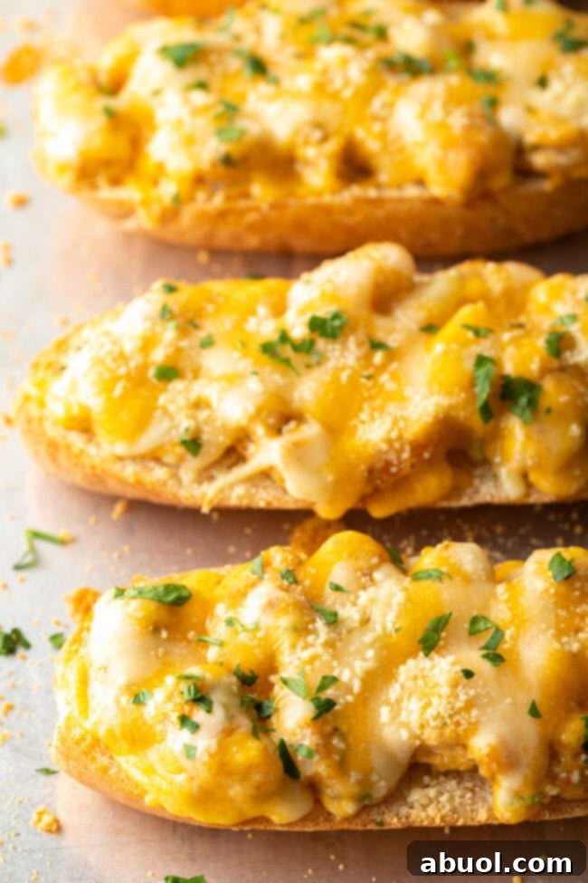 Freshly baked Salty Dog Cafe style shrimp toast on a baking sheet, with golden melted cheese and crispy bread edges.