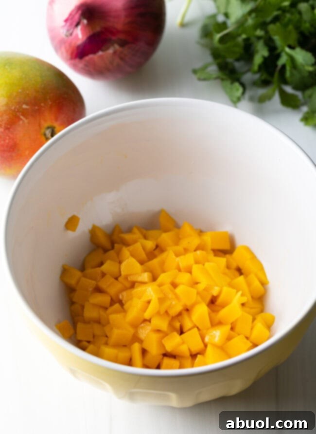 Bowl containing perfectly diced mango cubes, showcasing the fruit's vibrant color and texture.