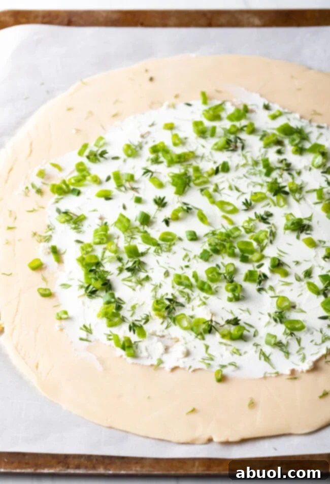 Sprinkling fresh herbs like thyme and dill over the tomato and goat cheese filling.