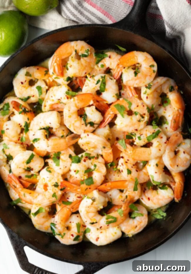 Top-down view of vibrant tequila lime sautéed shrimp in a rustic skillet, ready to serve.
