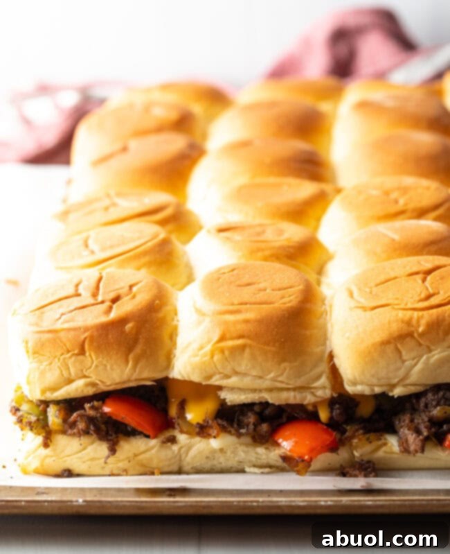 Baked steak sliders on a pan.
