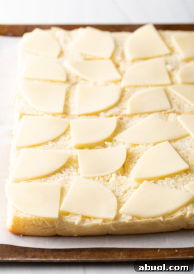Bottom of rolls with pieces of cheese.