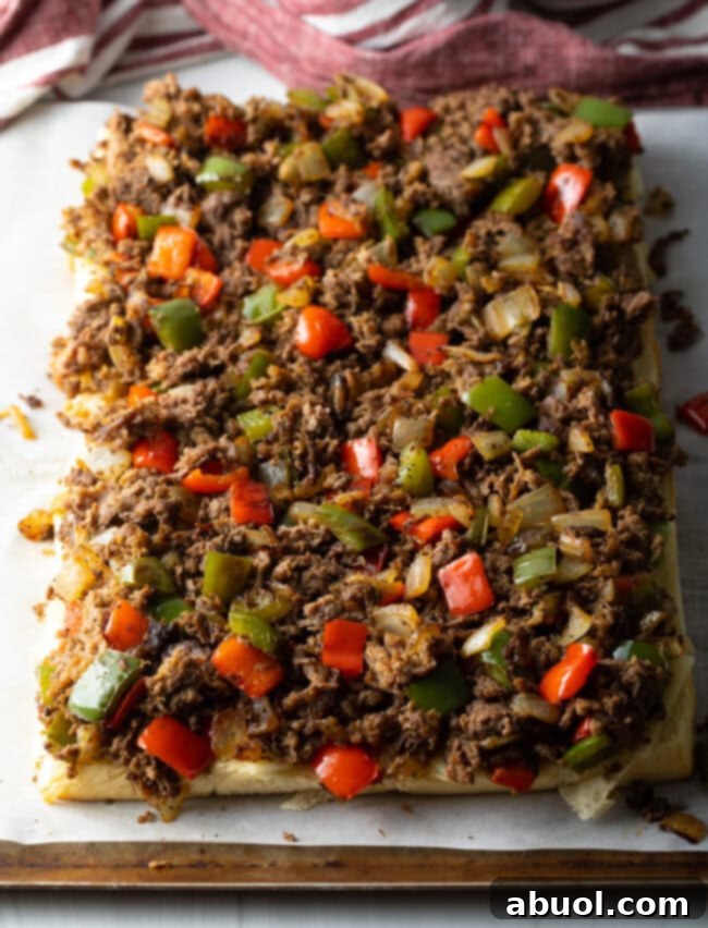 Steak and pepper mixture on the bottom rolls.