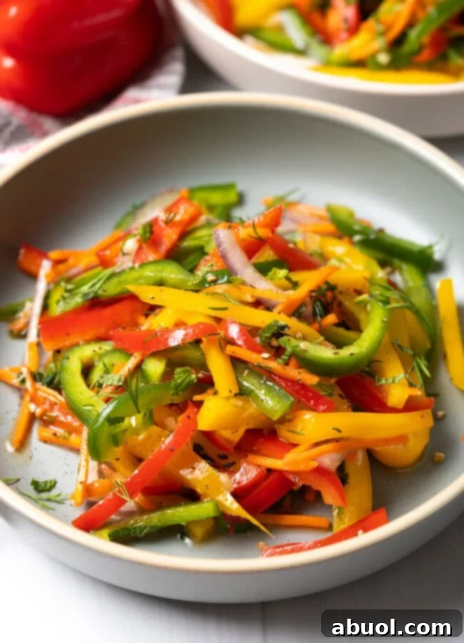 Colorful Pepper Medley 2 Yellow, green and red bell pepper summer salad served in an elegant white plate.