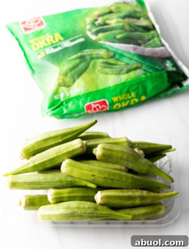 Selection of fresh, whole raw okra pods next to a bag of frozen whole okra, highlighting ingredient options.