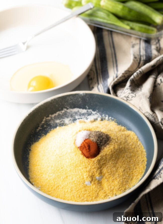 A bowl filled with a perfectly mixed breading blend of cornmeal, flour, and aromatic spices.