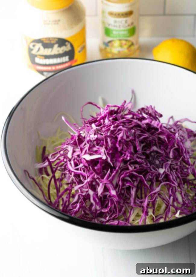 Shredded red and green cabbage in a bowl, showing the vibrant color combination.