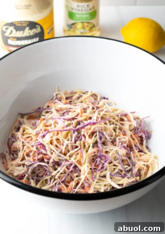 Top down view of a full bowl of creamy coleslaw, garnished and ready to serve.