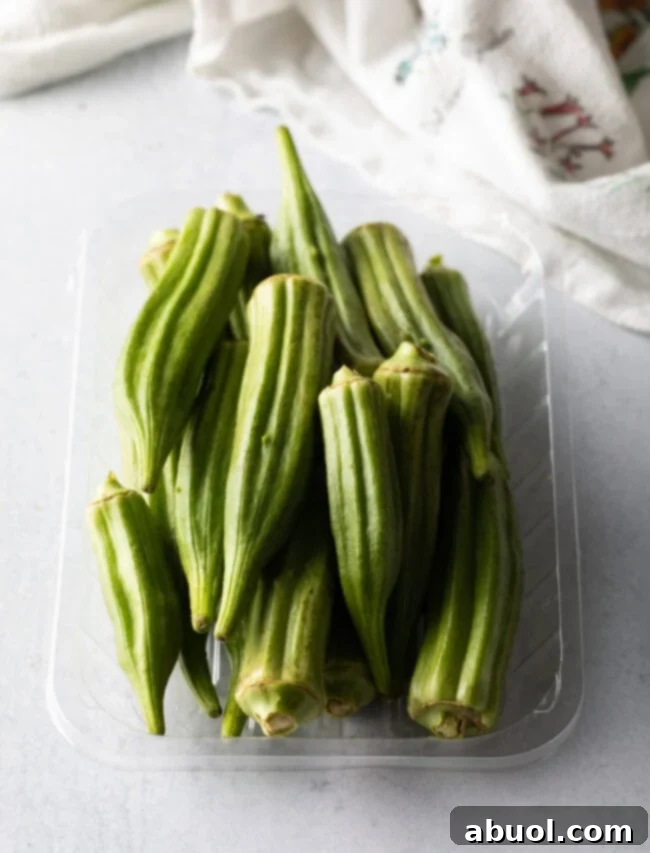 Raw whole okra in a plastic container