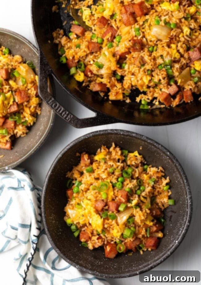 Top down view bowl of hawaiian fried rice with skillet.