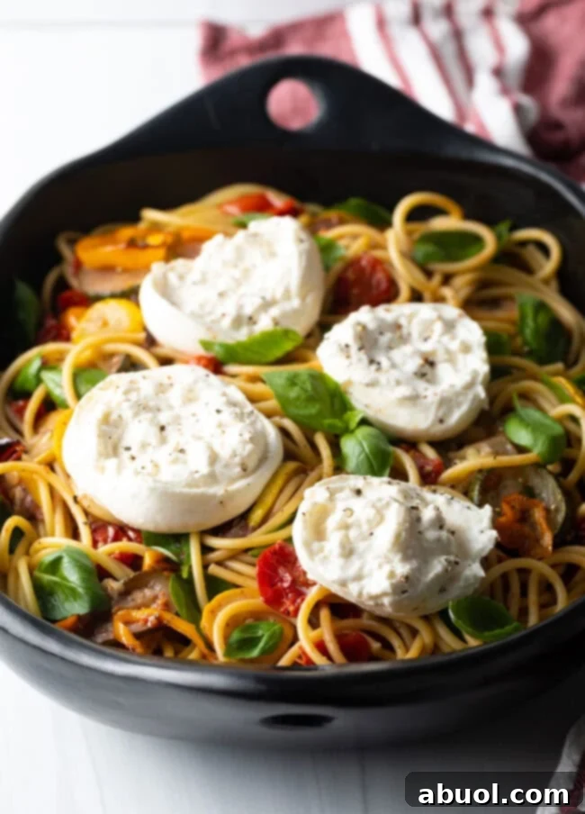 Spaghetti with veggies and cheese.