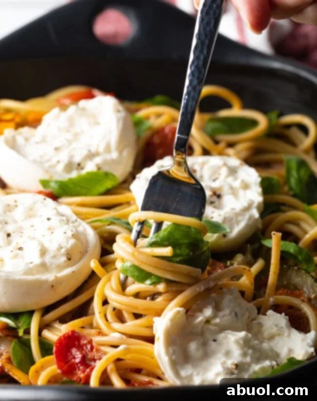 Close view fork twisting pasta and cheese.