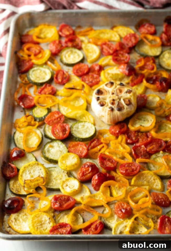 Roasted summer vegetables on a sheet pan.