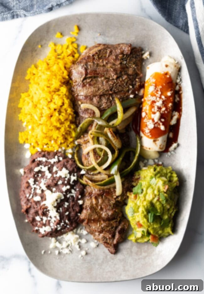 Plate of tampiquena steak with guacamole, rice, and beans
