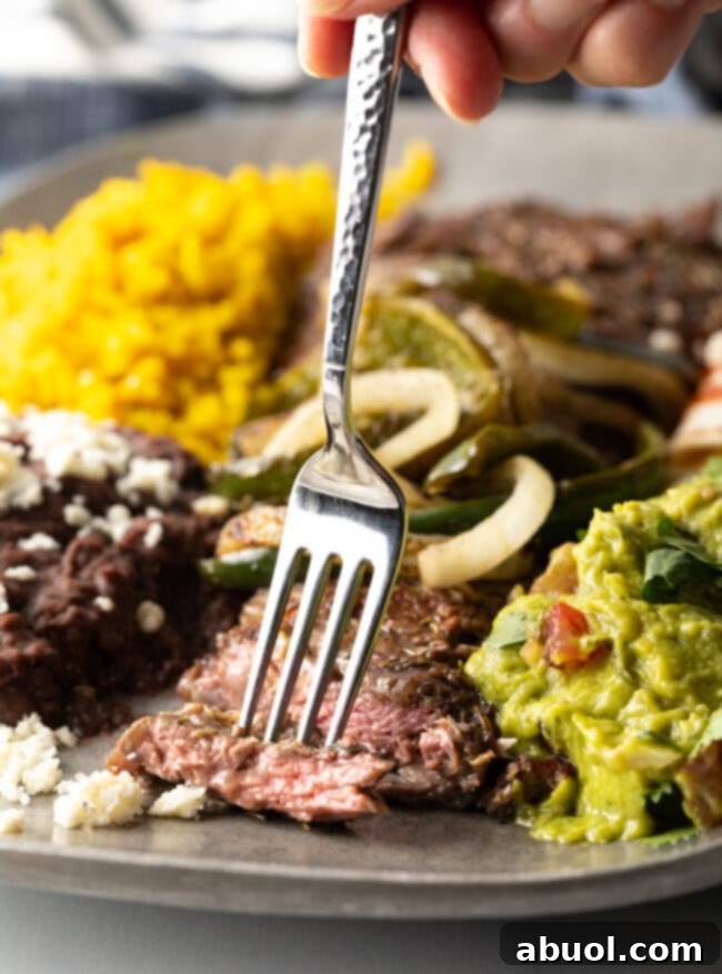 steak tampiquena on plate with bite taken from sliced meat
