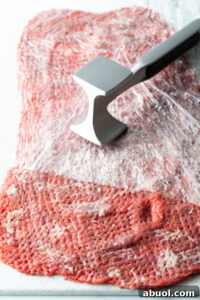 pounding skirt steak out flat with a meat mallet