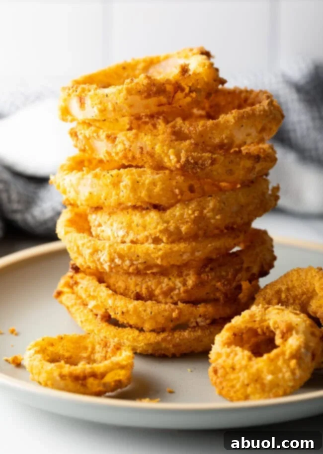 Stack of crispy air fried onion rings.