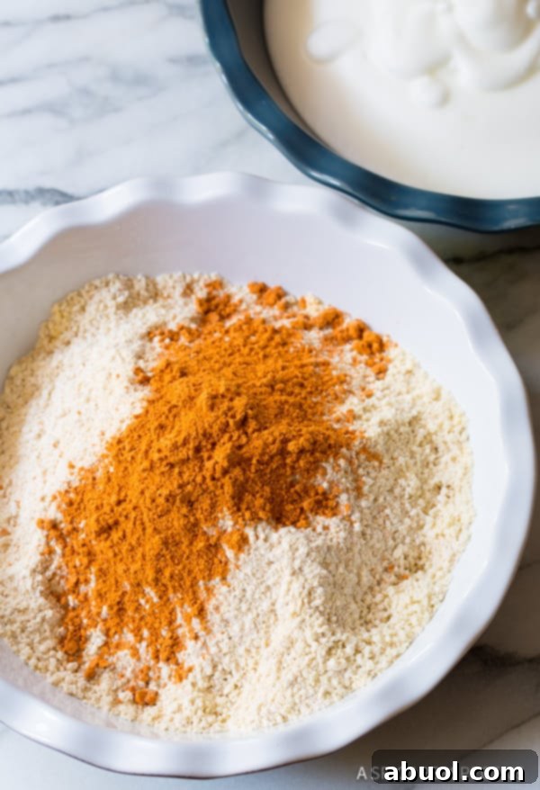 Seasonings for onion rings in a mixing bowl.