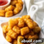 Crispy Air Fryer Tater Tots ready to be served from the air fryer basket.