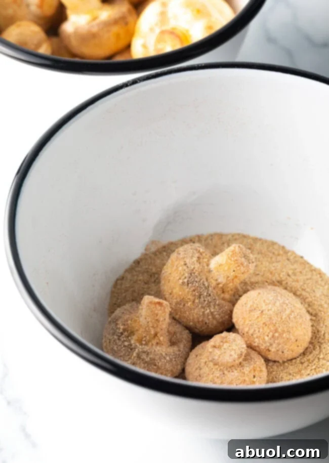 Raw mushrooms in a breading mixture.