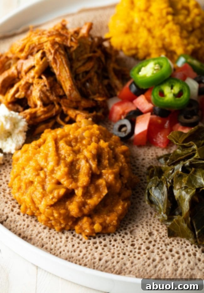 Ethiopian lentils and other foods on top of Injera.
