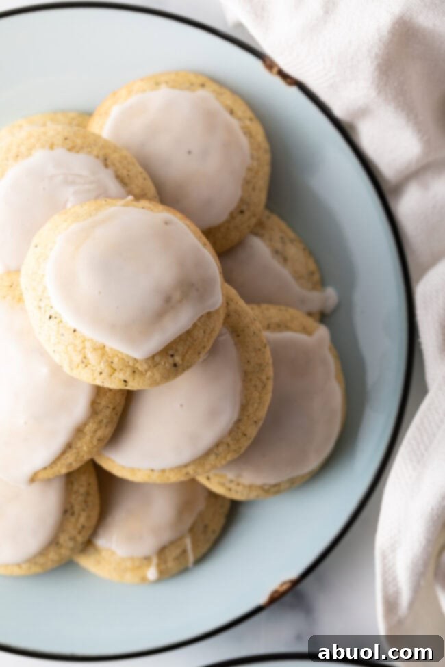 Top-down view of Earl Grey cookies, glistening with lemon glaze on a baking rack.