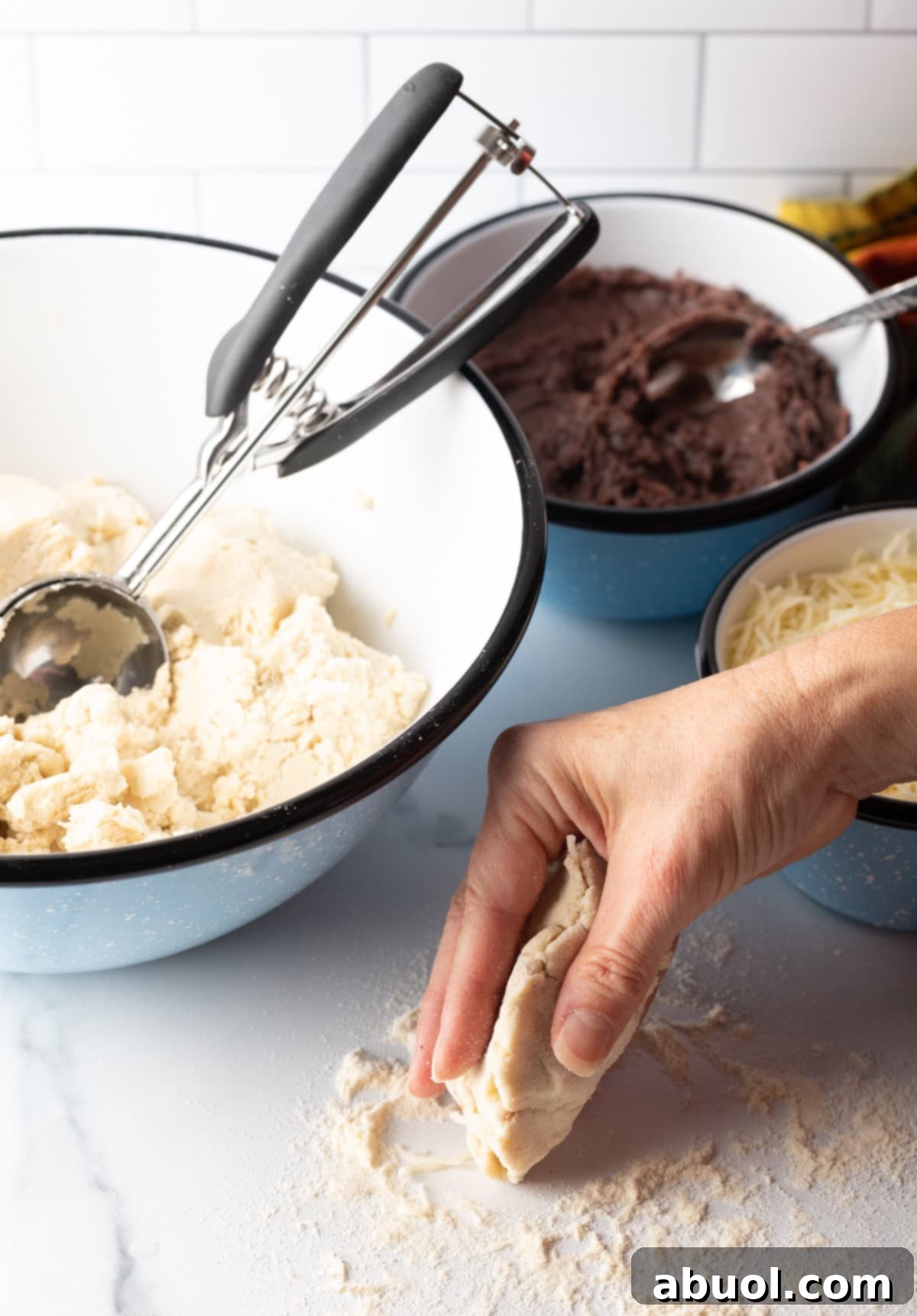 A hand carefully shaping the dough to enclose the filling, demonstrating the technique.