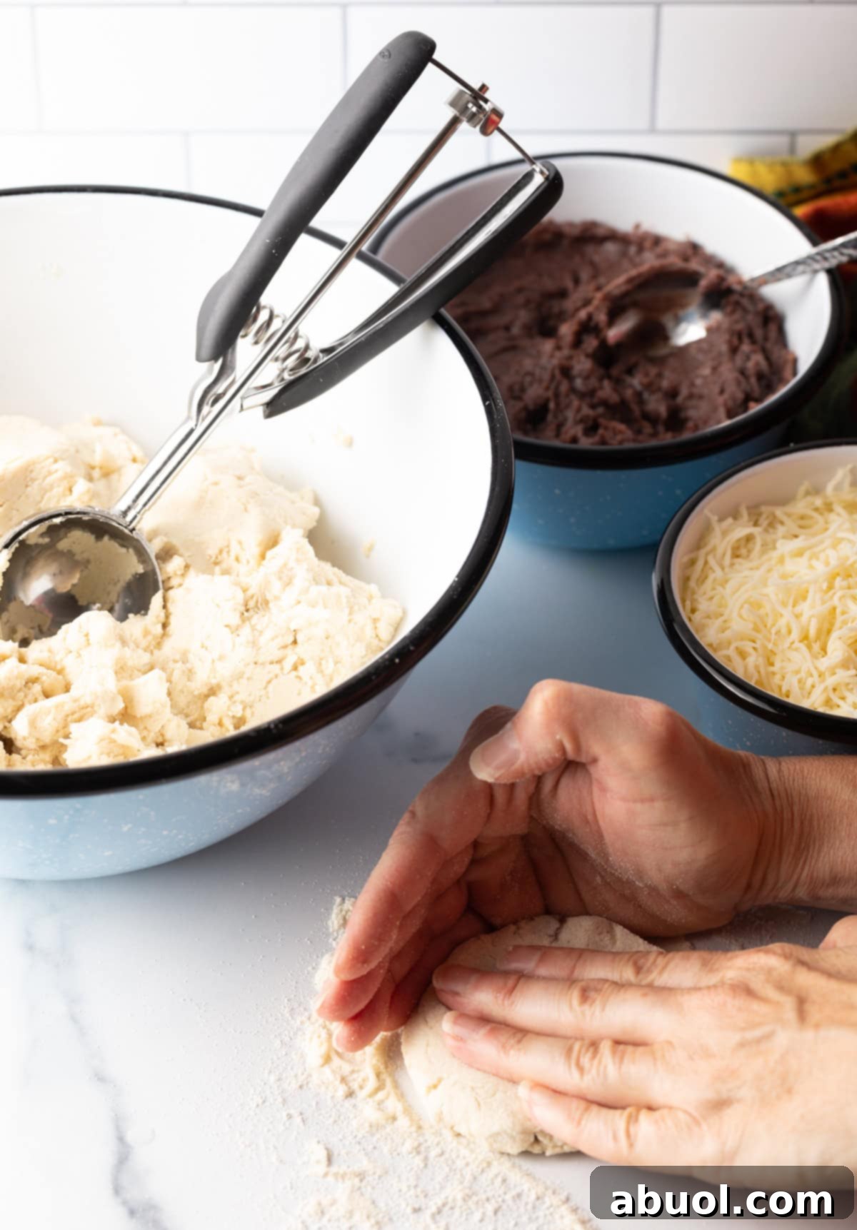 A hand gently flattening the sealed dough ball into a thick, round disk, ensuring even distribution of filling.