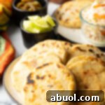 A freshly cooked pupusa with a golden-brown, slightly crispy crust, showcasing its appealing texture.