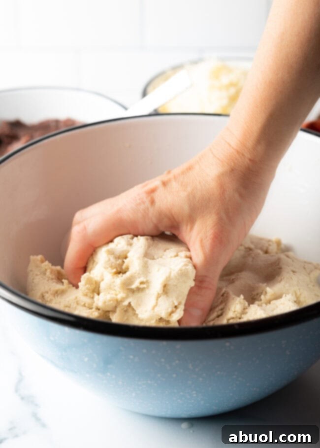 A skilled hand meticulously shaping masa harina and water into a smooth, soft, and perfectly pliable pupusa dough.