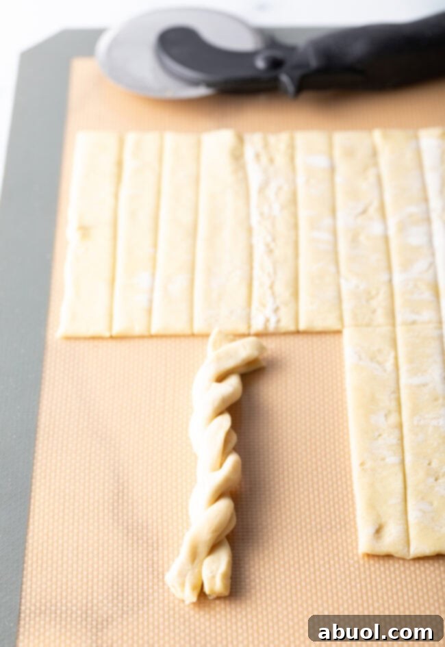A single braided puff pastry twist, perfectly shaped and ready for coating.