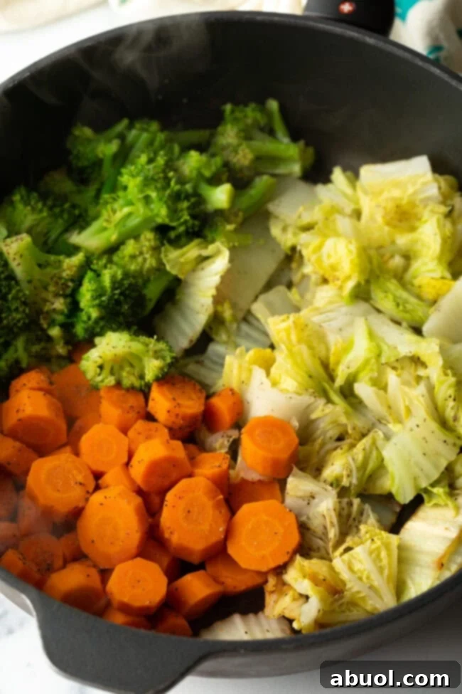 Steaming veggies in a skillet.