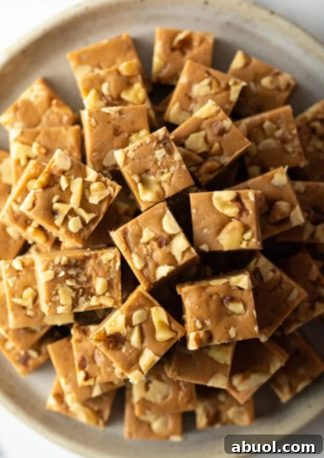 Top down view maple fudge stacked on a plate.
