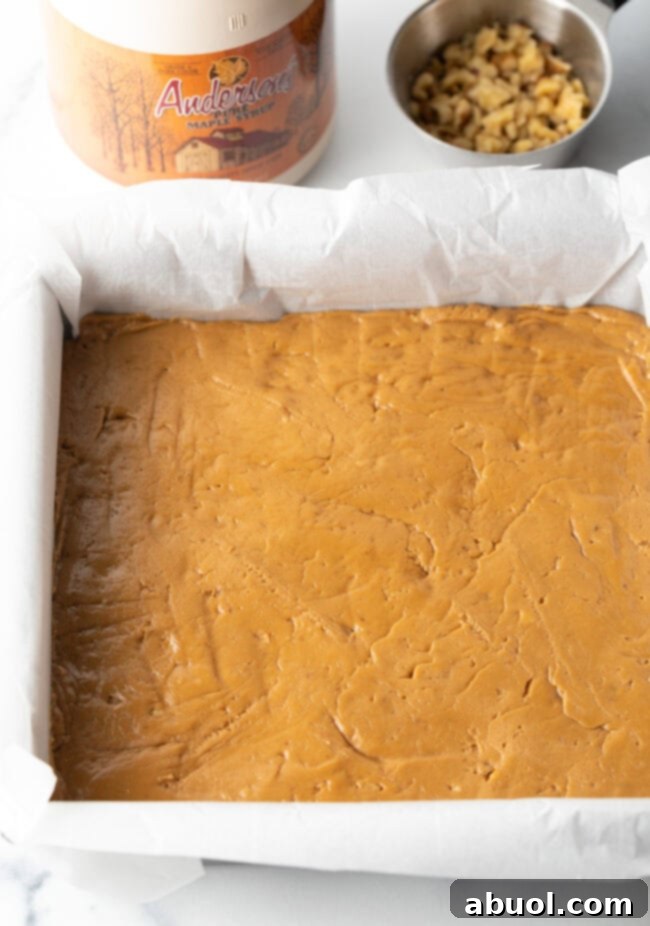 Mixture pressed into a square pan lined with parchment paper.