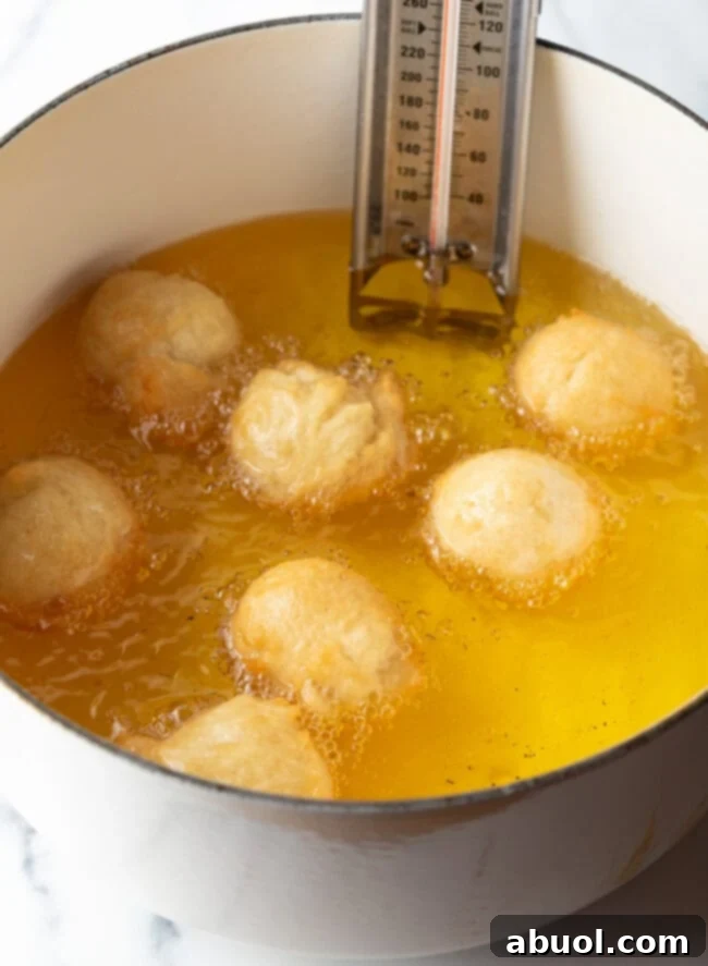 Dough balls frying in oil.