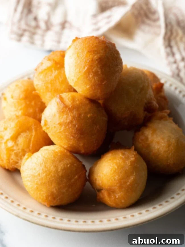 Fried dough balls on a plate.
