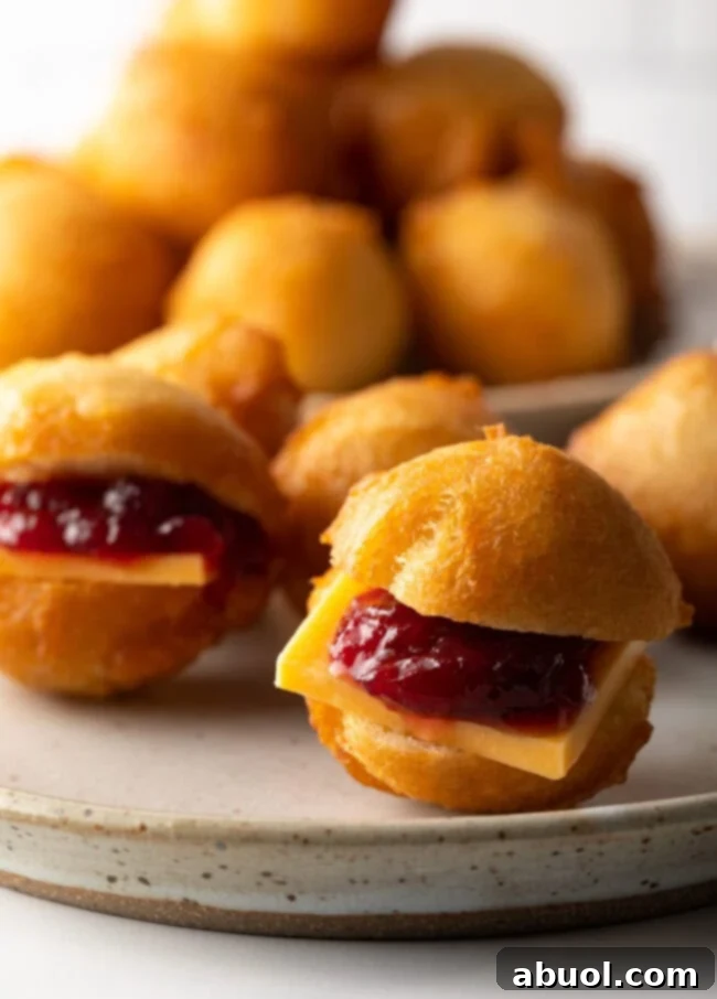 Close view vetkoek with jam and cheese.