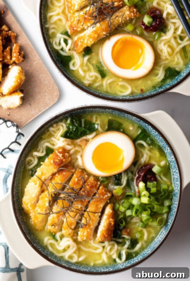Top-down view of two ornate bowls of Chicken Katsu Ramen, richly garnished and ready to eat.