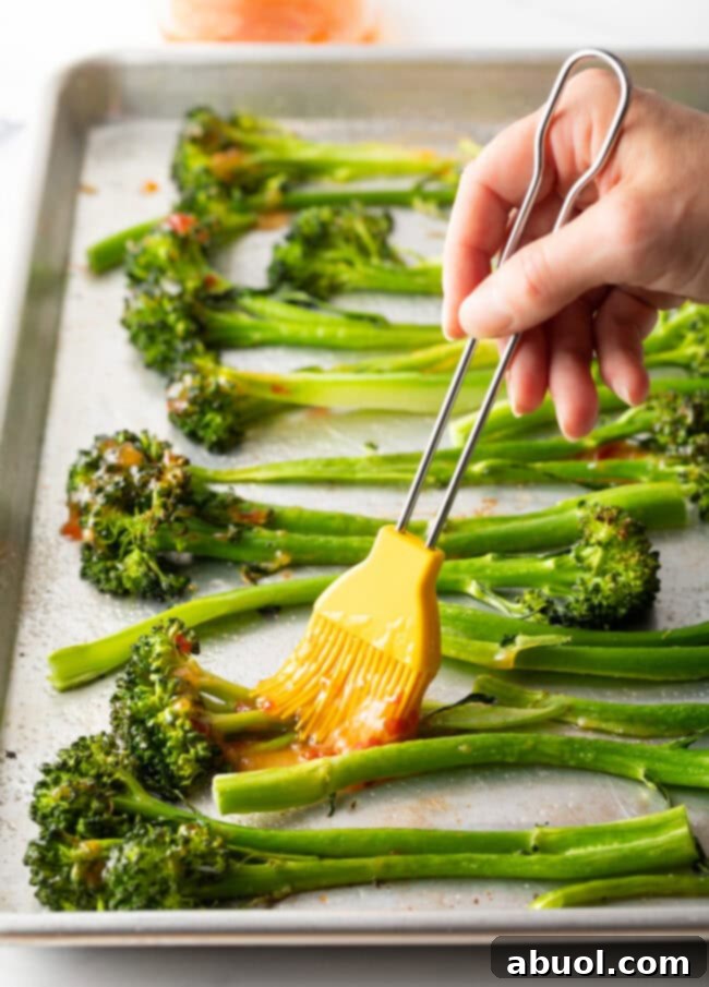 Brushing the sweet chili glaze on roasted broccolini
