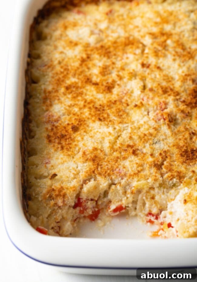 Golden Cheesy Hominy Bake 11 Baked casserole with section removed.