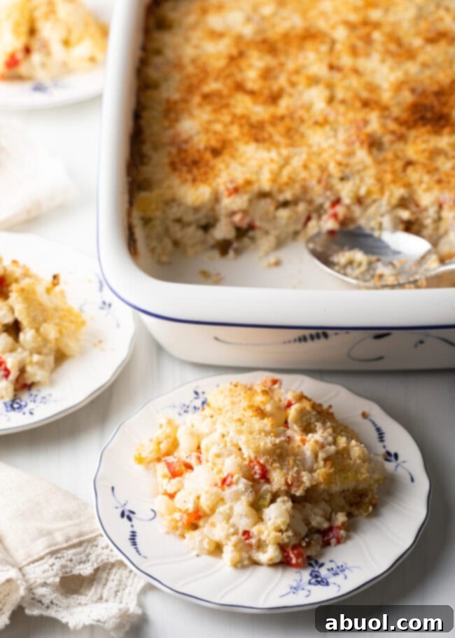 Golden Cheesy Hominy Bake 12 Cheesy hominy casserole portion on a plate.