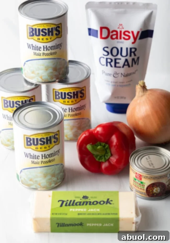 Golden Cheesy Hominy Bake 5 Ingredients needed: chiles, canned hominy, block of cheese, peppers and onion, sour cream.