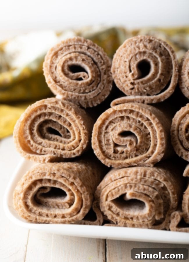 Rolled up Injera bread, beautifully presented on a wooden board, emphasizing its rustic and authentic appearance.