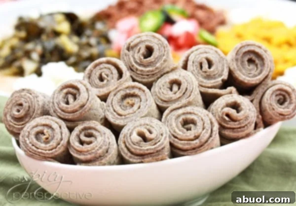 Rolled up Injera bread, showcasing its flexible and soft texture after being perfectly cooked and prepared.