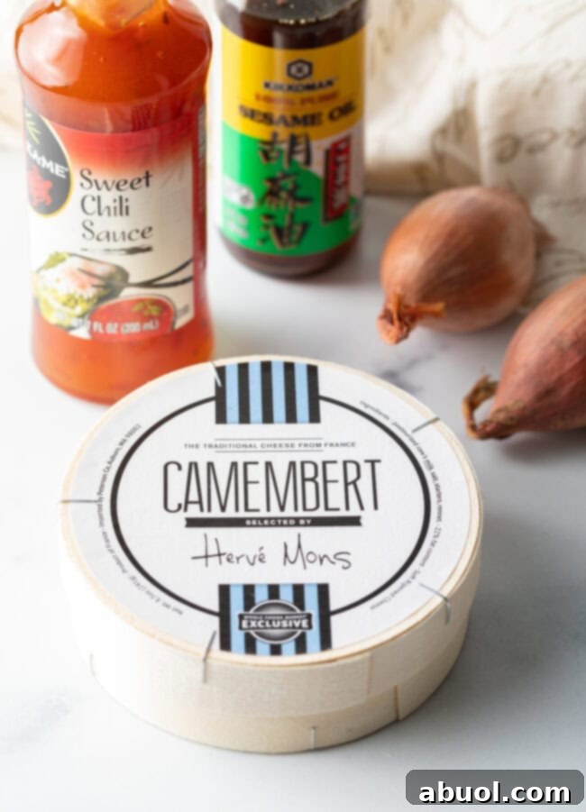 Ingredients you need: wheel of cheese, bottle of sweet chili sauce, sesame oil, and whole shallots.