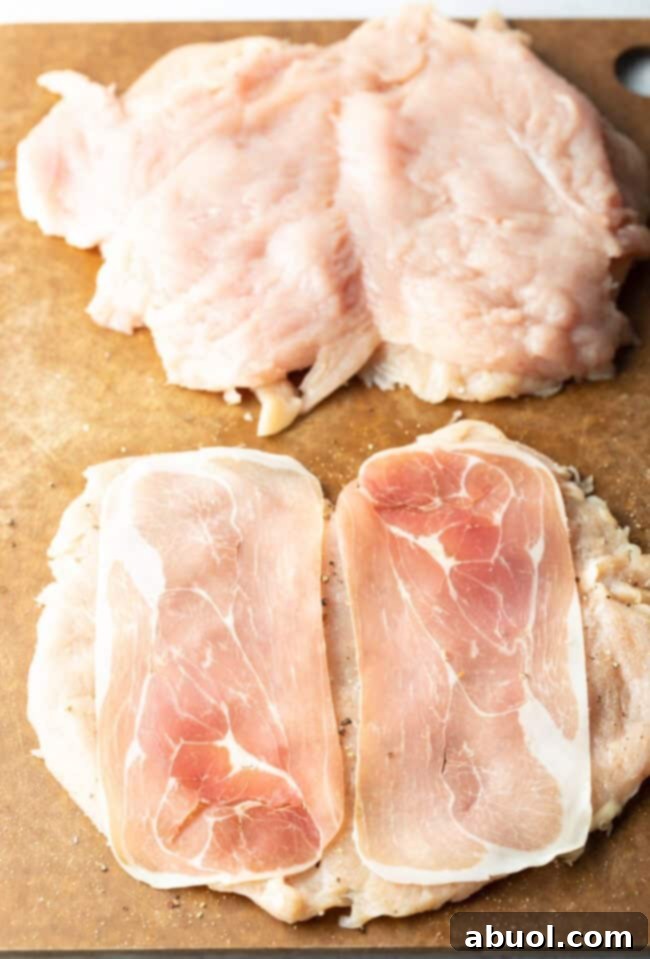 Butterflied chicken with slices of prosciutto on each half.